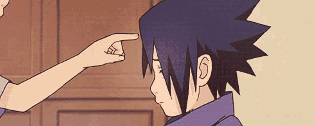 a person 's hand is pointing at a person 's face
