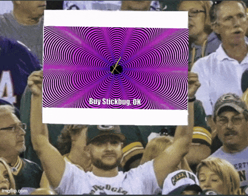 a man holds up a sign that says " buy stickbug ok "