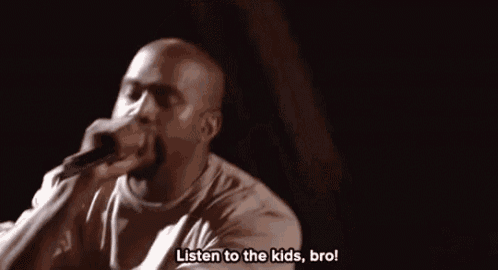 a man is speaking into a microphone and saying `` listen to the kids , bro '' .
