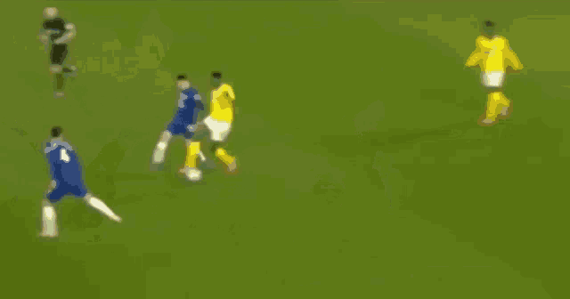 a group of soccer players are playing on a field .