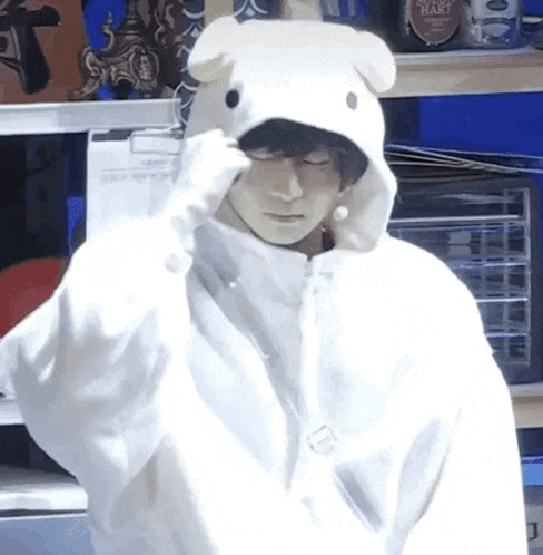 a person wearing a white hoodie with a bunny ear on it