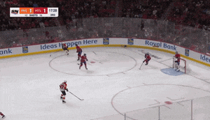 a hockey game is being played in a stadium with advertisements for royal bank