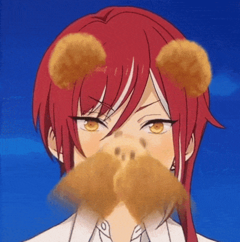 a girl with red hair and yellow eyes is wearing a teddy bear face mask