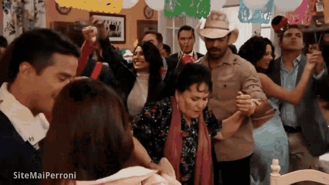 a group of people are dancing in a room with sitemailperroni written on the bottom right