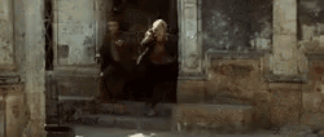 a woman is walking out of a doorway in a building .
