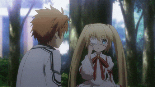 a boy and a girl are standing next to each other in a forest
