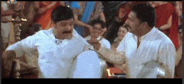 two men in white shirts are playing drums in front of a crowd with a watermark that says ' snl '