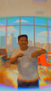 a man is standing in front of a window in a room with a blurry background .