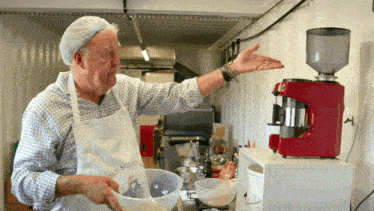 a man wearing an apron that says " holy squid "