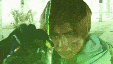 a close up of a person with a green background