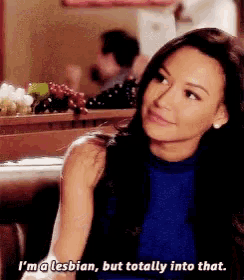 a woman in a blue shirt says i 'm a lesbian but totally into that .