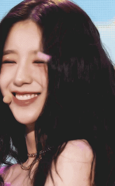 a close up of a woman 's face with a smile