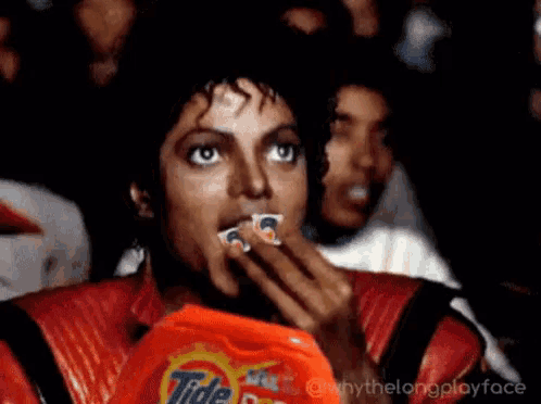 a person holding a bag of tide laundry detergent in front of their face