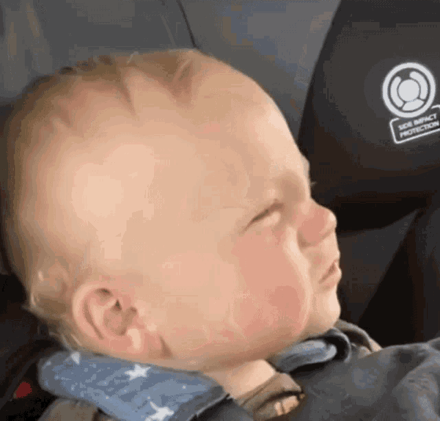 a baby is sitting in a car seat with a sticker on the back that says " soil impact protection "