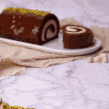 a chocolate roll cake with a slice taken out of it is on a white plate .