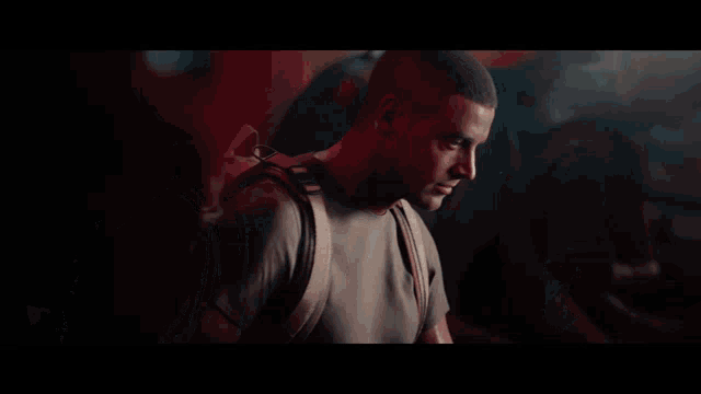a man with a backpack on his back looks to the side