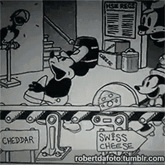 a black and white cartoon of mickey mouse and minnie mouse making swiss cheese .