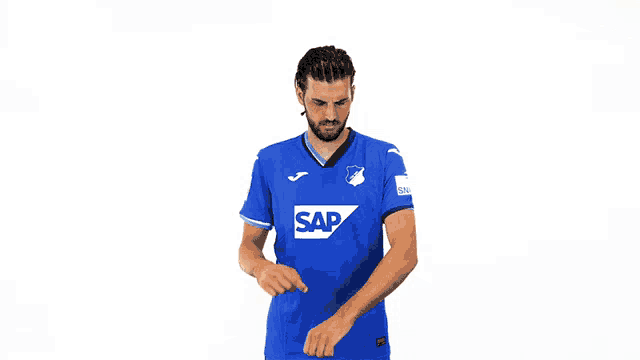 a man wearing a blue shirt with the word sap on the front