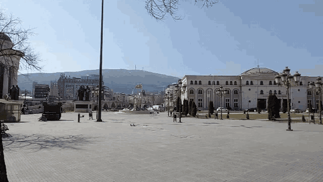 an empty city square with a statue in the middle