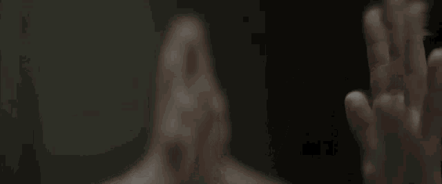 a person covering their face with their hands