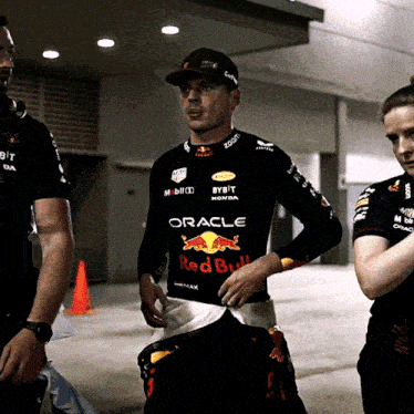 a man wearing a black shirt that says oracle on it