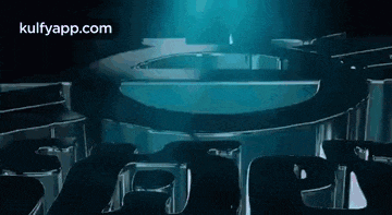 a dark room with a blue light shining through the ceiling