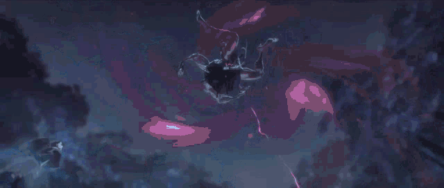 a person is holding a sword in their hand in a dark room with a blue light coming out of it .