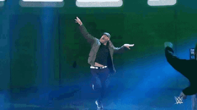 a man with a beard is dancing on a stage .