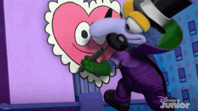 a cartoon character from disney junior is kissing a pink heart on the wall