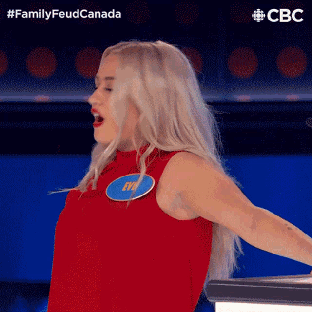 a woman in a red top with a name tag that says rye on it