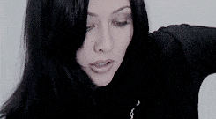 a close up of a woman wearing a black shirt