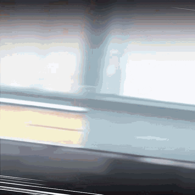 a blurred image of a window with a reflection of the sun