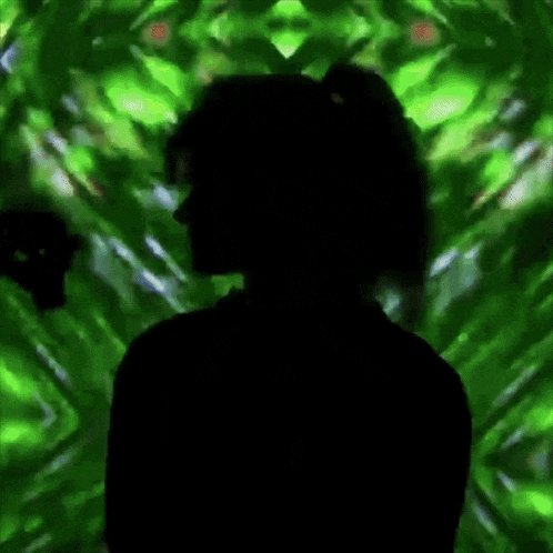 a silhouette of a woman is against a green background