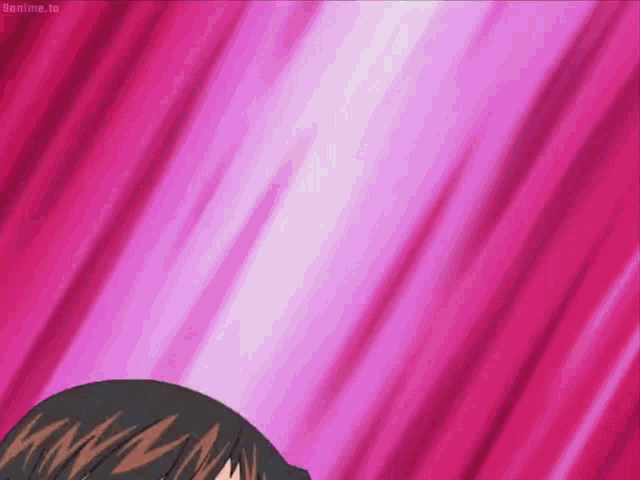 a person is standing in front of a pink background with a purple light coming out of it .