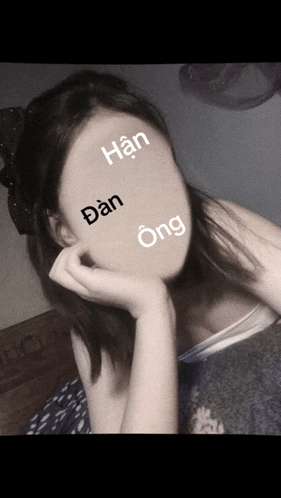a woman 's face is obscured by foreign writing including han dan and ong
