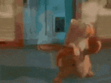 a cartoon cat is standing on its hind legs in front of a blue door