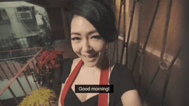 a woman says good morning in front of a window