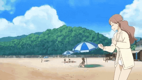 a woman stands on a beach holding an umbrella