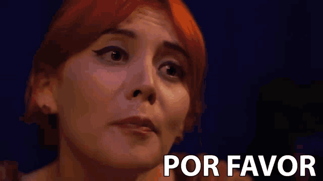 a woman with red hair says por favor in front of her face