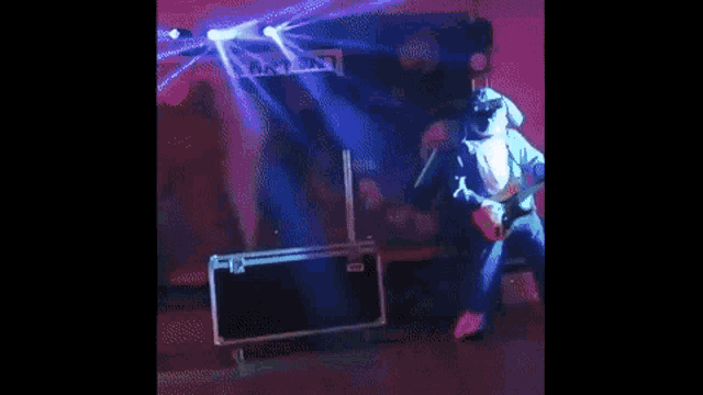 a man in a blue jacket is standing on a stage in front of a stage .