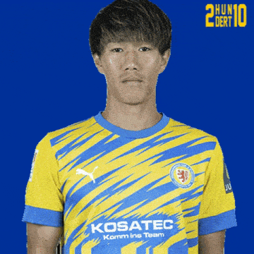 a soccer player wearing a yellow and blue jersey with kosatec written on the front