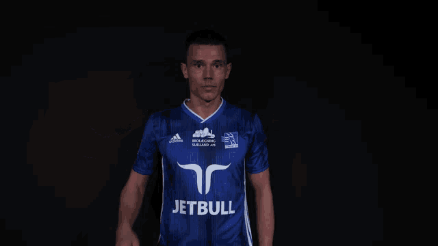 a man wearing a blue shirt that says jetbull on the front