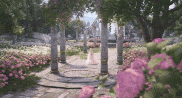 a woman in a pink dress is walking through a garden