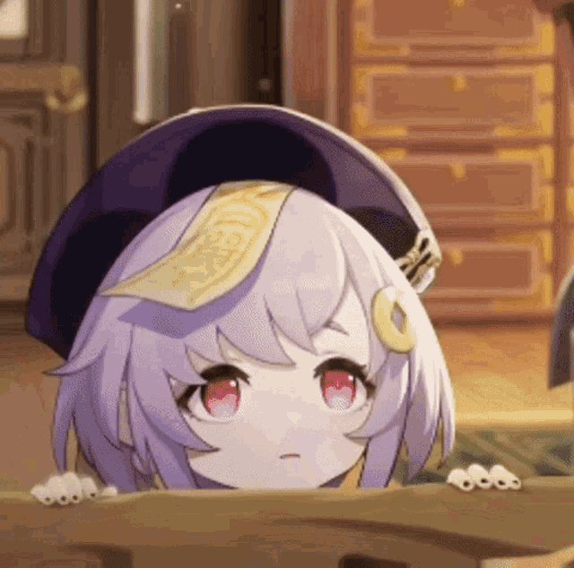 a little girl with purple hair and red eyes is peeking over a table .