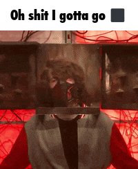 a man with a mask on his face is standing in front of a red light and says oh shit i gotta go .