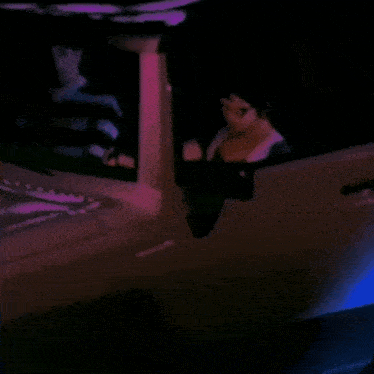 a doll is sitting in the driver 's seat of a car in the dark