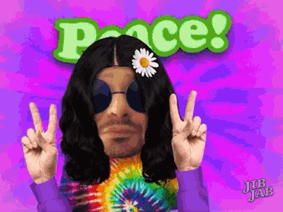 a man with a daisy in his hair giving a peace sign