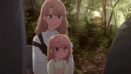 a woman is holding a little girl in her arms
