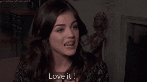 a woman says " love it " in front of a fireplace