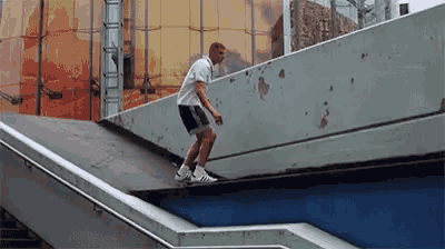 a man is doing a trick on a skateboard in front of a building